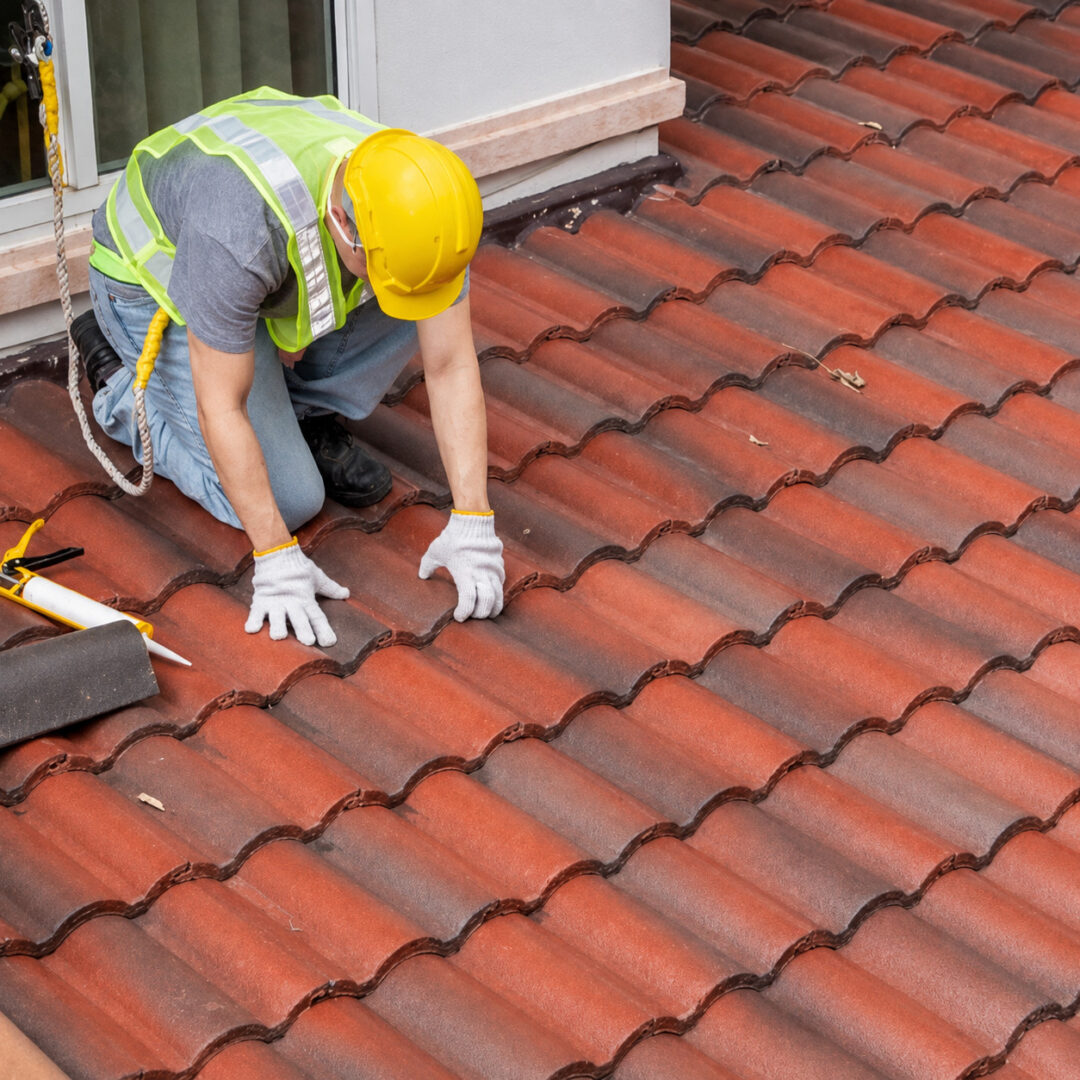 roofer-inspecting-terracotta-roof-tiles