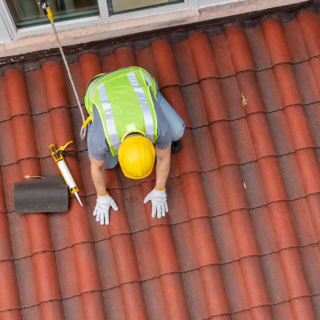 top-view-roofer-checking-clay-tile-roof
